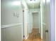 Hallway featuring hardwood floors, wainscoting, and doors leading to other rooms at 6470 Sherwood Trl, Austell, GA 30168