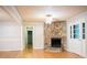 Cozy living room with stone fireplace, fan, and hardwood floors at 6470 Sherwood Trl, Austell, GA 30168