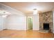 Open-concept living room features a stone fireplace, hardwood floors, and neutral paint, ideal for entertaining at 6470 Sherwood Trl, Austell, GA 30168