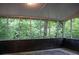 The screened-in porch offers views of surrounding greenery at 6470 Sherwood Trl, Austell, GA 30168