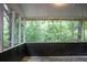 The screened-in porch offers views of surrounding greenery at 6470 Sherwood Trl, Austell, GA 30168