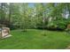 Expansive backyard with lush lawn and mature trees creating a private, serene setting at 1149 Midland Nw Dr, Acworth, GA 30102