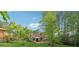 The home's backyard with beautiful trees and landscaping and a beautiful deck at 1149 Midland Nw Dr, Acworth, GA 30102