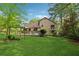 The home's backyard features a deck, mature trees and lovely landscaping at 1149 Midland Nw Dr, Acworth, GA 30102