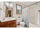 Bathroom with a wooden vanity, shower-tub combo and natural light offers a functional and inviting space at 1149 Midland Nw Dr, Acworth, GA 30102