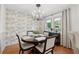 Chic dining room with floral wallpaper, modern lighting, and seating for four at 1149 Midland Nw Dr, Acworth, GA 30102