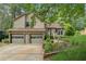 Charming home featuring a two-car garage, landscaped yard, and welcoming front porch at 1149 Midland Nw Dr, Acworth, GA 30102