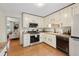Functional kitchen with white cabinets, stainless steel appliances, and hardwood floors at 1149 Midland Nw Dr, Acworth, GA 30102