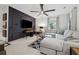 Open-concept living room features a large sectional, modern ceiling fan, and a sleek TV mounted on an accent wall at 1149 Midland Nw Dr, Acworth, GA 30102
