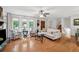 Sunlit living room showcases hardwood floors, comfortable seating, and large windows at 1149 Midland Nw Dr, Acworth, GA 30102