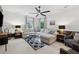 Bright living room with a large sectional sofa, stylish ceiling fan, and patterned rug creates a cozy atmosphere at 1149 Midland Nw Dr, Acworth, GA 30102