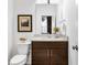 Bathroom with a dark wood vanity, granite countertops, framed print and modern fixtures at 2498 Perry Nw Blvd, Atlanta, GA 30318