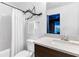 Stylish bathroom featuring a modern vanity, decorative tree branch, and tub-shower combo at 2498 Perry Nw Blvd, Atlanta, GA 30318