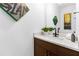 Modern bathroom features dark wood vanity cabinet, white countertop, modern faucet and decorative painting at 2498 Perry Nw Blvd, Atlanta, GA 30318