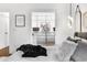 Bright bedroom features a closet, hardwood floors, decorative mirrors, and a patterned rug at 2498 Perry Nw Blvd, Atlanta, GA 30318