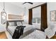 Bright bedroom features a large window with curtains, hardwood floors, decorative mirrors, and a patterned rug at 2498 Perry Nw Blvd, Atlanta, GA 30318