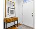 Inviting entryway with hardwood floors, a wood console table, framed print, decorative mirror and a woven rug at 2498 Perry Nw Blvd, Atlanta, GA 30318