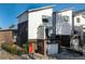 Modern townhome with a brick facade, white siding, and a bright red front door at 2498 Perry Nw Blvd, Atlanta, GA 30318