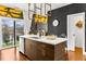 Modern kitchen island with white countertop, wood cabinets, stainless steel appliances and access to the outdoor patio at 2498 Perry Nw Blvd, Atlanta, GA 30318