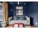 Comfortable blue living room showcases stylish daybed, ottoman, and decor at 2498 Perry Nw Blvd, Atlanta, GA 30318