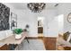 Home office with decorative chandelier, accent art, open shelving and adjacent door leading to a bathroom at 2498 Perry Nw Blvd, Atlanta, GA 30318