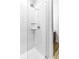 Close up of the white tiled shower with glass surround and modern fixtures at 2498 Perry Nw Blvd, Atlanta, GA 30318