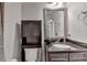 Well-lit bathroom featuring granite counters, under sink storage, and decorative vanity mirror at 2725 Monet Dr, Cumming, GA 30041