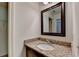 Bathroom featuring granite countertops, a decorative framed mirror, and modern fixtures at 2725 Monet Dr, Cumming, GA 30041