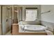 Relaxing bathroom featuring a large soaking tub, separate shower, and natural light at 2725 Monet Dr, Cumming, GA 30041