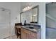 Bathroom with vanity, sink, mirror, and granite counters at 2725 Monet Dr, Cumming, GA 30041