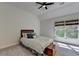 This bedroom has neutral colored walls and carpet, a bed, and a window at 2725 Monet Dr, Cumming, GA 30041