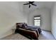 This bedroom has a ceiling fan, neutral colored walls and carpet and a large bed at 2725 Monet Dr, Cumming, GA 30041