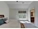 This bedroom has neutral colored walls and carpet, a bed, a window, and an attached bathroom at 2725 Monet Dr, Cumming, GA 30041