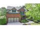Charming two-story brick home featuring a well-manicured lawn and attached two-car garage at 2725 Monet Dr, Cumming, GA 30041