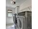 Modern laundry room featuring a stainless washer and dryer at 2725 Monet Dr, Cumming, GA 30041