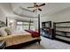 Large main bedroom with trey ceiling, ceiling fan, TV, and oversized windows at 2725 Monet Dr, Cumming, GA 30041