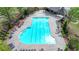 Aerial view of a large community swimming pool with chairs, tables, and lush landscaping at 2725 Monet Dr, Cumming, GA 30041