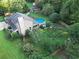 Aerial view of a home featuring a pool, well-maintained lawn, and a cozy outdoor area at 4364 Saddlecreek Ct, Auburn, GA 30011