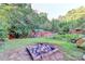 Backyard fire pit surrounded by trees at 4364 Saddlecreek Ct, Auburn, GA 30011