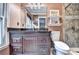 This bathroom features a large mirror, granite countertop, and tiled shower at 4364 Saddlecreek Ct, Auburn, GA 30011