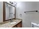 Half bathroom with granite countertop and ornate mirror above the sink at 4364 Saddlecreek Ct, Auburn, GA 30011