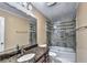 This bathroom features a granite countertop, basin sink, and tiled shower/bath combo at 4364 Saddlecreek Ct, Auburn, GA 30011