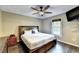 This bedroom features hardwood floors, ceiling fan, large bed, and a window at 4364 Saddlecreek Ct, Auburn, GA 30011