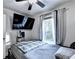 Cozy bedroom with a comfortable bed, tv, ceiling fan, and a bright window at 4364 Saddlecreek Ct, Auburn, GA 30011