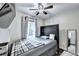 Modern bedroom featuring a bed, ceiling fan, and window for natural light and comfort at 4364 Saddlecreek Ct, Auburn, GA 30011