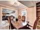Traditional dining room with wood table, upholstered chairs, and view to living area at 4364 Saddlecreek Ct, Auburn, GA 30011