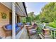 Inviting front porch featuring comfortable wicker furniture, creating a cozy outdoor living space at 4364 Saddlecreek Ct, Auburn, GA 30011