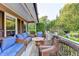Relaxing outdoor porch area complete with comfortable seating arrangements, overlooking a serene front yard at 4364 Saddlecreek Ct, Auburn, GA 30011