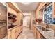 Galley kitchen with granite countertops, stainless steel appliances, and custom backsplash at 4364 Saddlecreek Ct, Auburn, GA 30011