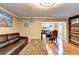 Spacious living room with hardwood floors, a cozy sofa, and seamless flow into the dining area at 4364 Saddlecreek Ct, Auburn, GA 30011